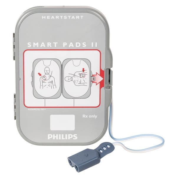 Boîtier Philips HeartStart FRx SMART Pads II contenant une paire d'électrodes de défibrillation, avec illustration de positionnement sur un adulte.